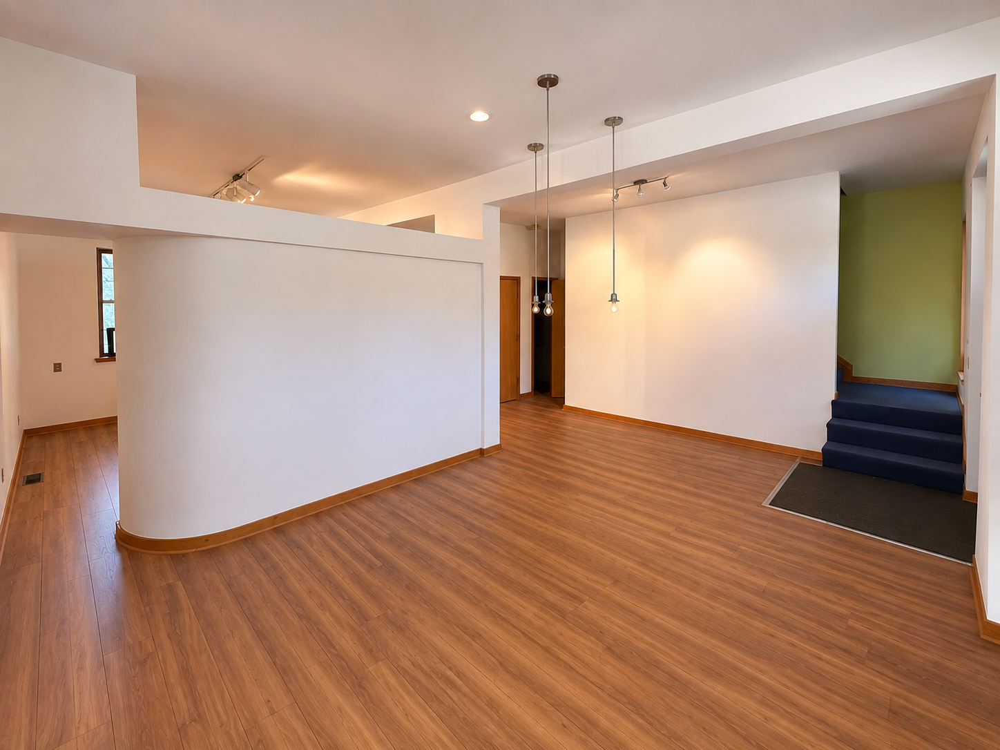Bright empty event room with white walls and wood floors